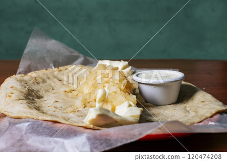 Close up of Nicaraguan Quesillo served on wooden table. Traditional Nicaraguan Quesillo served on wooden table, Traditional Nicaraguan Quesillo served on wooden table with copy space Close up of Nicaraguan Quesillo served on wooden table. Traditional Nicaraguan Quesillo served on wooden table, Traditional Nicaraguan Quesillo served on wooden table with copy space 120474208