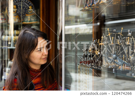 Woman choosing old-fashioned souvenirs in shop 120474266
