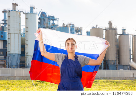 Serious young woman holds the national flag of Russia Serious young woman holds the national flag of Russia 120474593
