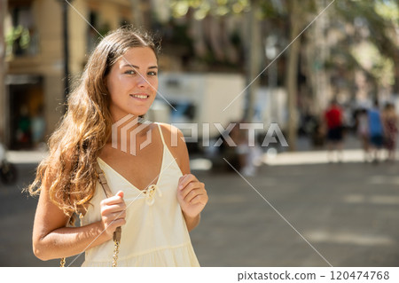 In pedestrian zone of historic European city walking female tourist girl 120474768