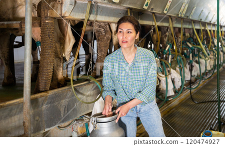 Asian female posing with milk can at the cow farm Asian female posing with milk can at the cow farm 120474927