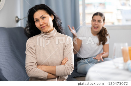 Young female couple quarreling at home Young female couple quarreling at home 120475072