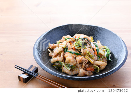 Pork kimchi served on a black plate (wood grain background) 120475632