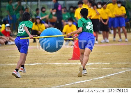 Junior high school students carrying balls at a sports day Junior high school students carrying balls at a sports day 120476113