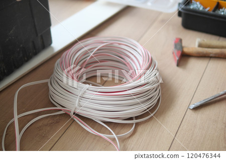 The thick white wire on floor The thick white wire on floor 120476344