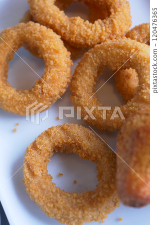Deliciously Crispy Golden Fried Onion Rings Served Beautifully on a Plate for You Deliciously Crispy Golden Fried Onion Rings Served Beautifully on a Plate for You 120476365