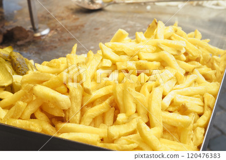 A Pile of Golden Crispy French Fries Located in a Bustling Fast Food Setting Enjoying Popularity 120476383