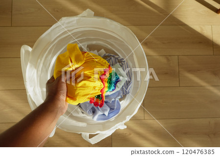 A Vibrant Laundry Basket Filled with Colorful Clothes Ready for Washing and Cleaning A Vibrant Laundry Basket Filled with Colorful Clothes Ready for Washing and Cleaning 120476385