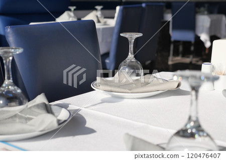 An Elegant Dining Setup featuring Beautiful Glasses and Plates for a Sophisticated Experience 120476407