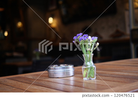 A Charming Table Setting with Fresh Beautiful Flowers in a Cozy and Inviting Cafe Atmosphere A Charming Table Setting with Fresh Beautiful Flowers in a Cozy and Inviting Cafe Atmosphere 120476521