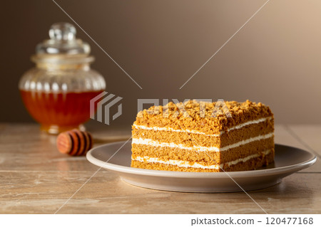 Traditional homemade honey cake on a beige background. Traditional homemade honey cake on a beige background. 120477168
