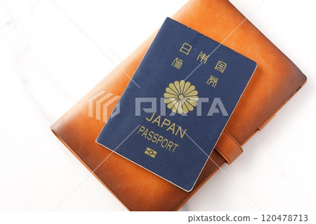 Image of someone preparing a Japanese passport (5-year ordinary navy blue passport) and planning a trip abroad Image of someone preparing a Japanese passport (5-year ordinary navy blue passport) and planning a trip abroad 120478713