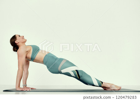 Fitness Trainer in Upward Plank Pose 120479283