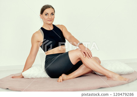 Relaxed Fitness Trainer Resting on Cushions. Relaxed Fitness Trainer Resting on Cushions. 120479286