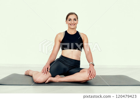 Seated Butterfly Stretch on the flor 120479423
