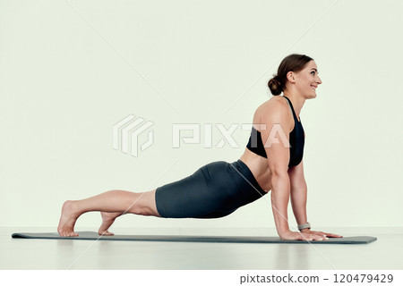 Fit Woman in Upward Dog Pose 120479429
