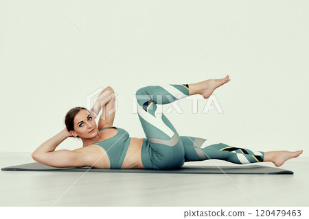 Fitness Trainer Performing Bicycle Crunch for Core Workout Fitness Trainer Performing Bicycle Crunch for Core Workout 120479463