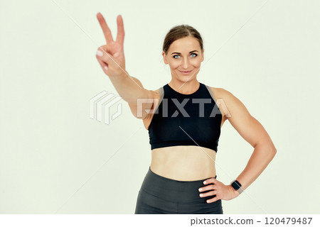 Motivated Fitness Trainer Showing Peace Sign. Motivated Fitness Trainer Showing Peace Sign. 120479487