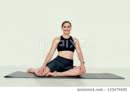 Seated Forward Bend Stretch on the flor 120479498