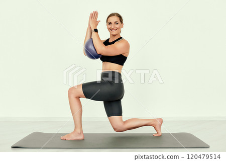 Standing Lunge with Exercise Ball Hold. 120479514