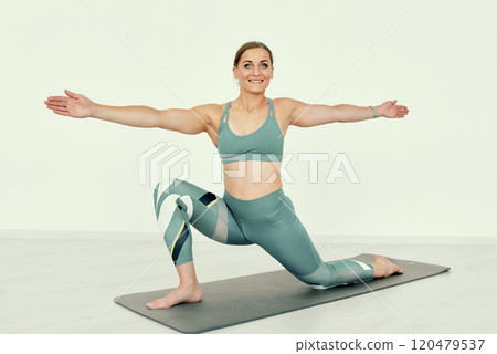 Fitness Trainer Demonstrating Lunge Stretch with Open Arms. Fitness Trainer Demonstrating Lunge Stretch with Open Arms. 120479537