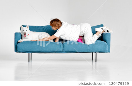 Playful Moment Between Woman and Husky on Couch Playful Moment Between Woman and Husky on Couch 120479539