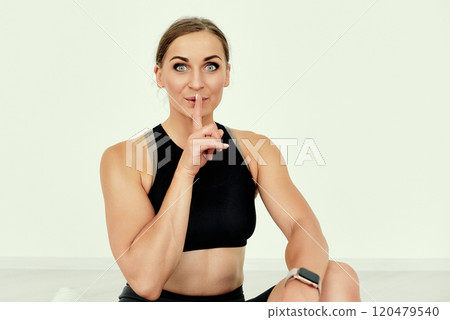 Fitness Trainer Gesturing Silence on white background 120479540