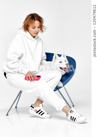 Woman and Husky Relaxing with Smartphone 120479612