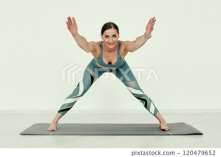 Wide-Legged Forward Fold Stretch Exercise. Wide-Legged Forward Fold Stretch Exercise. 120479652
