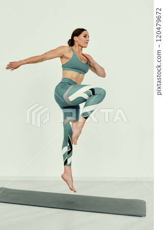 Fitness Trainer Mid-Jump for High-Intensity Training 120479672