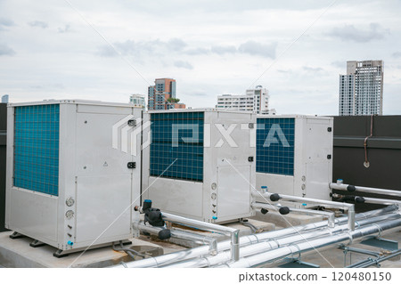 Air conditioner compressor installed on roof building. Industrial air conditioning units. Industrial air conditioning and ventilation systems on roof. Cooling towers in data center building. Air conditioner compressor installed on roof building. Industrial air conditioning units. Industrial air conditioning and ventilation systems on roof. Cooling towers in data center building. 120480150