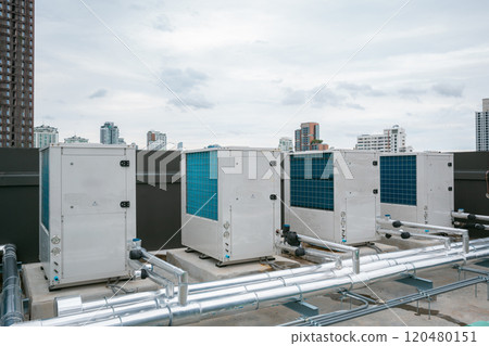 Air conditioner compressor installed on roof building. Industrial air conditioning units. Industrial air conditioning and ventilation systems on roof. Cooling towers in data center building. Air conditioner compressor installed on roof building. Industrial air conditioning units. Industrial air conditioning and ventilation systems on roof. Cooling towers in data center building. 120480151