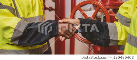 Close up engineer's hands work checking Fire suppression system and fire equipment. Engineer check red generator pump for water sprinkler piping and fire alarm control system Close up engineer's hands work checking Fire suppression system and fire equipment. Engineer check red generator pump for water sprinkler piping and fire alarm control system 120480408