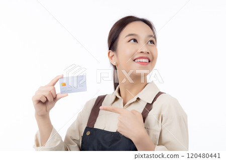 Portrait happiness young asian woman wearing apron holding and pointing credit card. 120480441