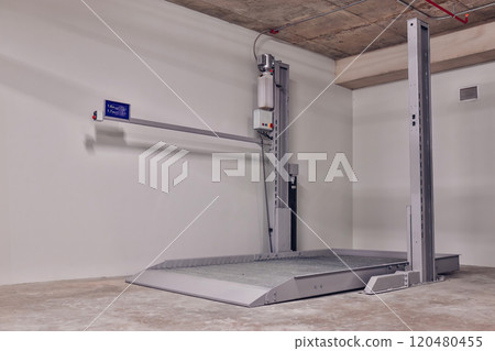 Empty Space in Automatic Elevator double stack car park. Hydraulic lift. Empty garage. Hydraulic machine for lifting car indoor parking. Empty Space in Automatic Elevator double stack car park. Hydraulic lift. Empty garage. Hydraulic machine for lifting car indoor parking. 120480455