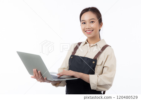 Portrait young asian business woman wearing apron holding laptop computer isolated. Portrait young asian business woman wearing apron holding laptop computer isolated. 120480529