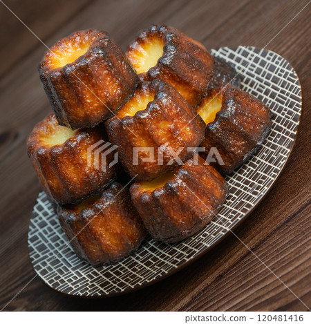 Canneles de bordeaux, traditional French sweet dessert with white table background 120481416
