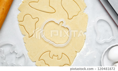 Making different shapes of fall cookies for Halloween. Dough with cookie cutter 120481872