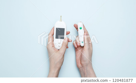 Woman hands holding glucometer for measuring blood glucose levels,  lancet. Concept of worldwide diabetes awareness 120481877