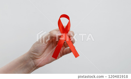 World AIDS Day. Woman holding red AIDS awareness ribbon World AIDS Day. Woman holding red AIDS awareness ribbon 120481918
