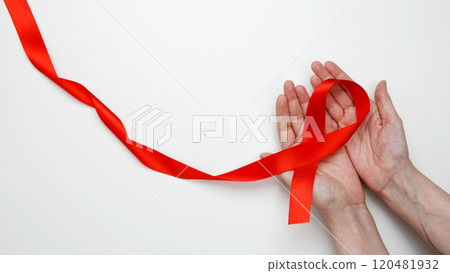World AIDS Day. Woman holding red AIDS awareness ribbon 120481932