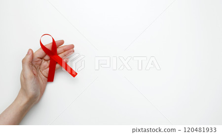 World AIDS Day. Woman holding red AIDS awareness ribbon World AIDS Day. Woman holding red AIDS awareness ribbon 120481933