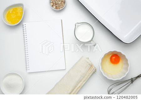 Cooking ingredients and notebook on a white background. For baking Crinkle Cake. Mockup design for recipe or food blog 120482005