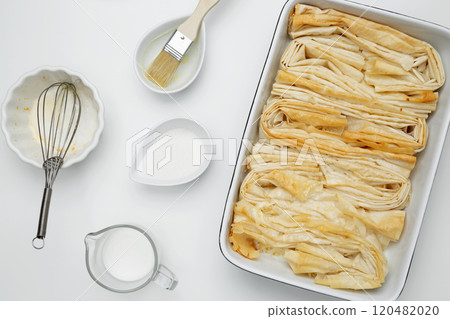 Baked phyllo dough for Crinkle Cake, mixing egg, milk and sugar to make custard 120482020