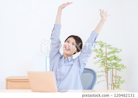 A woman with a bang working on a computer 120482131