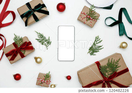 Christmas gifts wrapped with decorative elements, and smartphone mockup on display 120482226