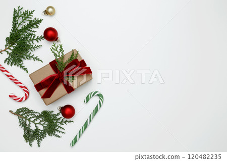 Wrapped Christmas gifts with green thuja branches creating a festive, natural holiday scene Wrapped Christmas gifts with green thuja branches creating a festive, natural holiday scene 120482235