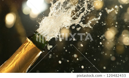 Celebration theme with splashing champagne on black background. Celebration theme with splashing champagne on black background. 120482433