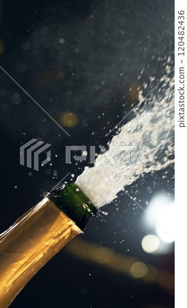 Celebration theme with splashing champagne on black background. 120482436