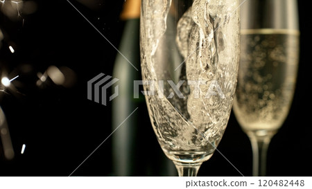 Pouring Champagne Wine into Glass, Isolated on Black Background. Pouring Champagne Wine into Glass, Isolated on Black Background. 120482448